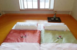 Säng eller sängar i ett rum på Okyeon Jeongsa
