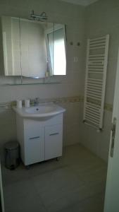 a bathroom with a white sink and a mirror at Apartment Vjera in Punat +45 photos