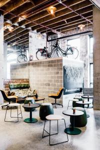a room with tables and chairs and bikes on a wall at Veriu Broadway in Sydney