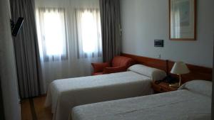 Cama o camas de una habitación en Hotel La Corza Blanca