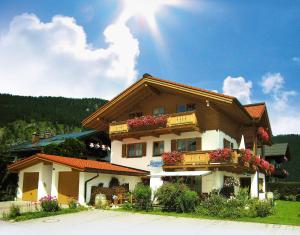 a building with flower boxes on the side of it at Gästehaus Bergwinkl in Reit im Winkl