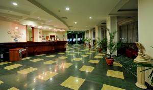 a lobby of a hospital with potted plants at Hotel Caesars Palace in Sunny Beach