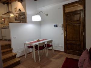 a kitchen with a table and two chairs and a door at La Casina di Perugia in Perugia