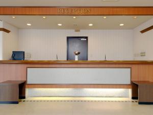 a waiting room with a reception counter in a hospital at Hotel Pearl City Hachinohe in Hachinohe