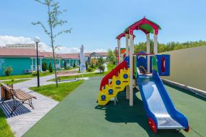 a playground with a slide in a park at Дача Del Sol Ultra All inclusive in Miracleon in Vityazevo