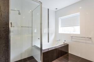 a bathroom with a glass shower and a sink at Your Home Away from Home in Melbourne