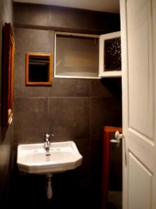 a small bathroom with a sink and a window at La Chaumière in Beuil