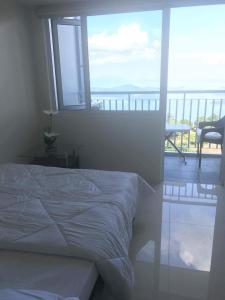 A bed or beds in a room at Taal View Condo by Liza