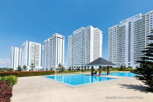 a swimming pool in front of some tall buildings at Taal View Condo by Liza in Tagaytay