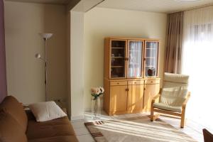 a living room with a couch and a cabinet at Ferienwohnung SONNENUHR in Bacharach