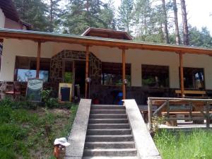 a house with a staircase leading up to it at Family Hotel Shisharka in Batak