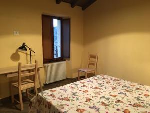 Letto o letti in una camera di Alloggio del Grand Tour