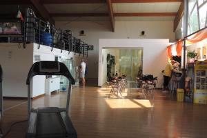 a room with chairs and tables and a room with people at Interno 132 in Porto San Giorgio