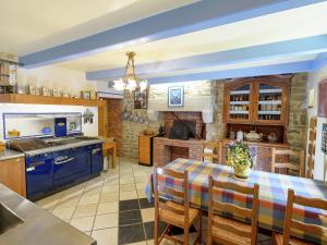 a kitchen with a table and a kitchen with blue cabinets at Villa 100 meters from the Atlantic in Plounéour-Trez