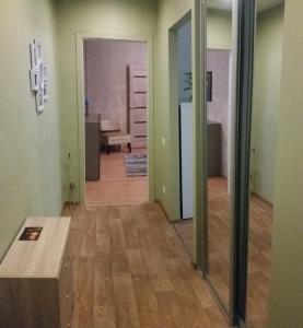 a living room with a wooden floor and green walls at Apartment on Brivzemnieka in Liepāja