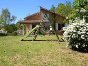 a swing set in the yard of a house at Modern vacation home with private garden in Bathernay