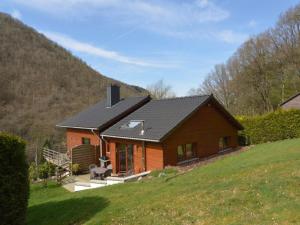 a house with a black roof on a hill at Cozy Cottage in Aywaille with Valley View in Aywaille