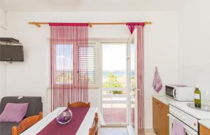 a kitchen with a table and a window at Apartmani Poljak in Kraj