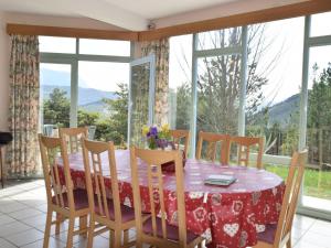 a dining room with a table and chairs and windows at House with private pool and beautiful view in Ponet-et-Saint-Auban