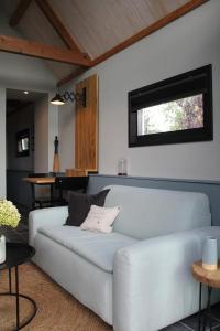 a living room with a couch and a table at Hoeve Altena Guesthouse in Woudrichem