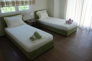 מיטה או מיטות בחדר ב-Infinity Blue Villa