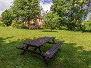 drewniany stół piknikowy na trawiastym polu w obiekcie Farmhouse in Saint Cybranet with Private Garden w mieście Saint-Cybranet