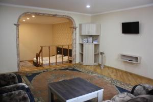 a living room with a bed and a table at Paradise Hotel in Tbilisi City