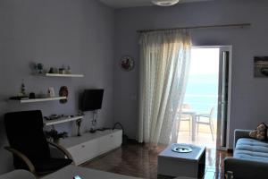 a living room with a view of the ocean at Seaside Apartment in Sarandë