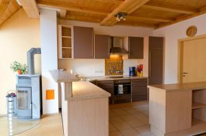 a kitchen with brown cabinets and a counter top at Ferienwohnung Pforte 7 in Dalheim