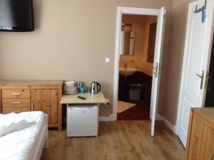 a bedroom with a small table and a sink at Villa Karolina in Mielno
