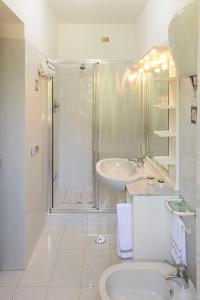a bathroom with a shower and a sink and a toilet at La Casa dei Pini in Gubbio