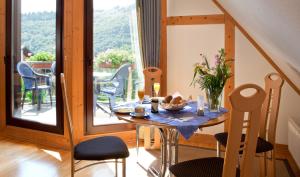 a dining room with a table and a large window at Ferienweingut Pies Ellenz-Poltersdorf in Ellenz-Poltersdorf