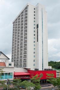 a large white building with a red building at Central Park Hotel & Casino in Panama City