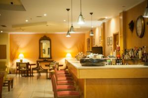 a restaurant with a bar and a dining room at Neda Hotel in Olympia