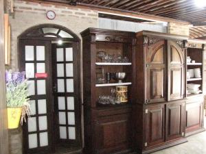 a large wooden cabinet in a room with a window at Pousada Joãozinho Caminhador in Recife