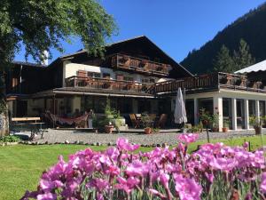 a house with pink flowers in front of it at Chalet l'Aiglon in Saint-Gervais-les-Bains