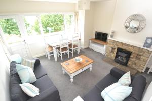 a living room with a couch and a table at Riverside Cottage in Wetherby