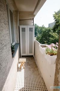 a bench sitting on a porch with a window at Warsaw Concierge Polin Apartment in Warsaw