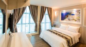 Postel nebo postele na pokoji v ubytování Lavender Inn USJ