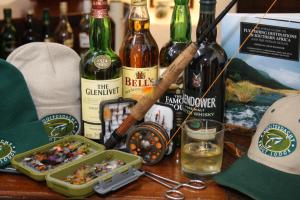 a table with bottles of wine and a tray of food at Nooitgedacht Trout Lodge in Lydenburg