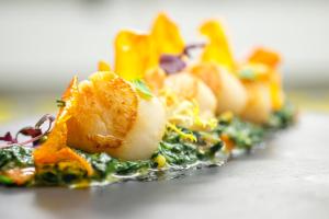 a row of food on a plate on a table at Finca Prats Hotel Golf & Spa in Lleida