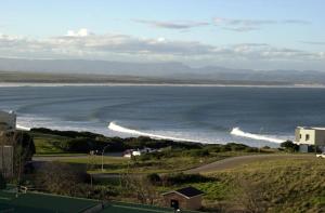 a view of a beach with waves in the water at JBay Surf View @ Point in Jeffreys Bay