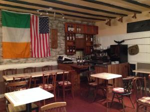 a restaurant with an american flag on the wall at Sheehans On Main Street in Kenmare