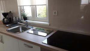 a kitchen counter with a sink and a window at Petra Rooms and Apartments in Rab +107 photos