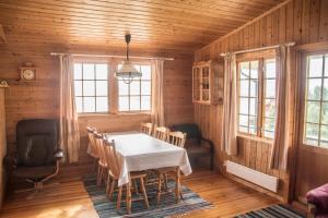 a dining room with a table and chairs at Seljenes Cottage in Russenes
