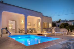 a backyard with a swimming pool and a house at Villa Evilia in Márpissa