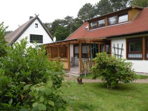 a house being remodeled with a porch and windows at Ferienhaus Dierhagen Strand I & II in Dierhagen
