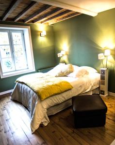 a bedroom with a large bed and a window at Les Parfums de Madeleine in Montbrison