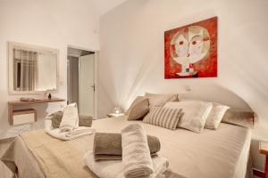 a bedroom with a large bed with towels on it at Villa Evilia in Márpissa +26 photos