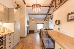 a kitchen and living room with a long counter top at The Old Hay Loft in Kirkby Lonsdale